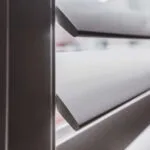 Wood shutters with the slanted louvers adds privacy and light control