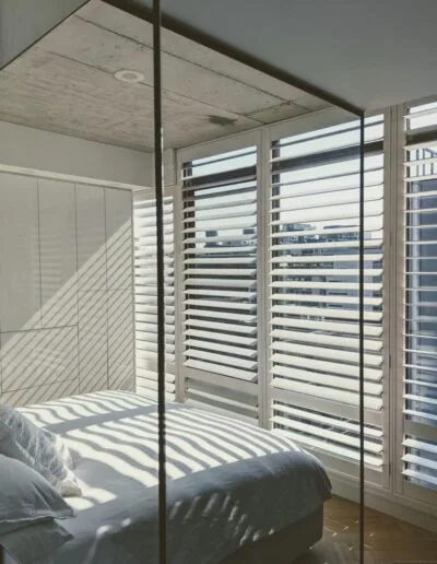 interior shutters in a condo bedroom